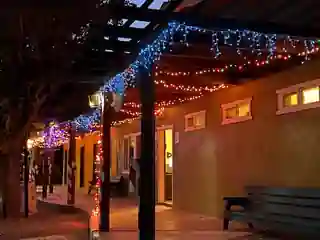 Door of Faith campground buildings and covered walkway decorated with lights at night