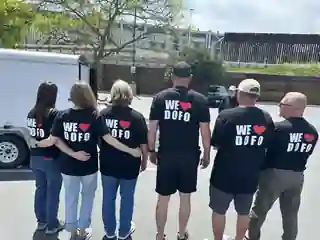 Mission team members standing together in We Love DOFO shirts